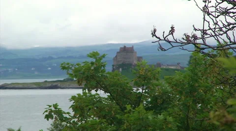 Old castle in the loch, behind tree branches Stock Footage 39815809