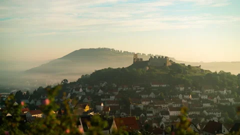 An old castle ruin in a small German town on a mountain in the morning with fog Stock Footage 201771128