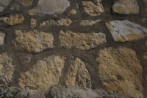 Old castle stone wall background. Part of a stone wall, for background or t.. Stock Photos