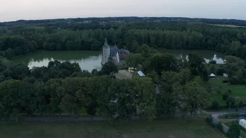 Old castle with tower and pond in the woods abandon dark blue atmosphere Aerial Stock Footage 123111472