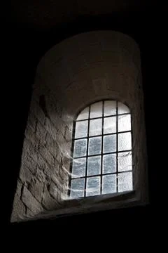 Old castle window in darkness Stock Photos
