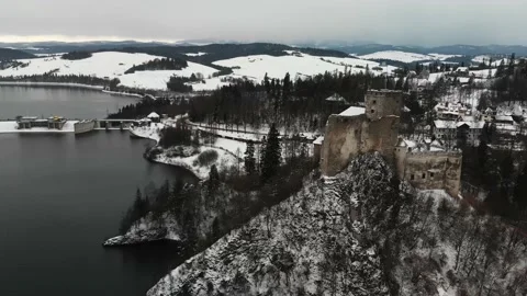 Old castle in the winter on the top of the hill next to a lake Stock Footage 232367221