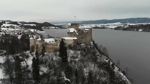 Old castle in the winter on the top of the hill next to a lake Stock Footage 232367243