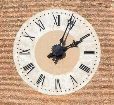 Old Cathedral clock on brick wall, Bassano, Italy Stock Photos