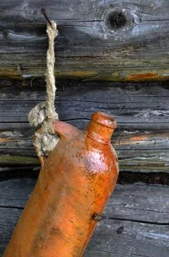 Old ceramic bottle on the wall Stock Photos
