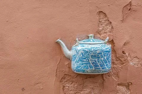 Old ceramic teapot embedded in a painted plastered wall Stock Photos