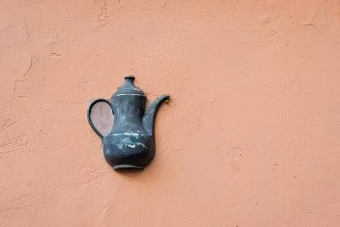Old ceramic teapot embedded in a painted plastered wall Stock Photos