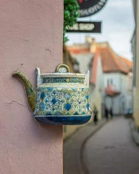 Old ceramic teapots embedded in a painted plastered wall Stock Photos