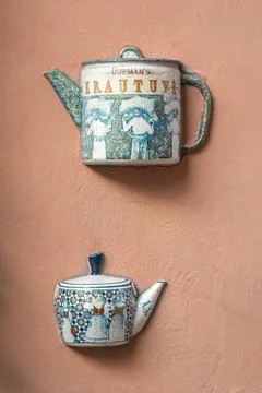 Old ceramic teapots embedded in a painted plastered wall Stock Photos