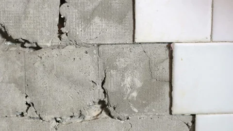 Old ceramic tiles falling off from the wall closeup Stock Footage 94099880