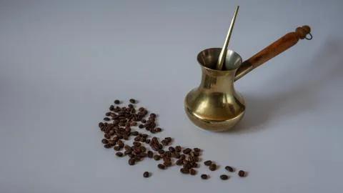 Old cezve copper coffee maker with wooden handle. Coffee beans. Turkish coffee. Stock Photos