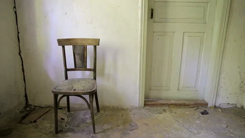 Old chair on the background of the door in the empty room. Stock Footage 102169300