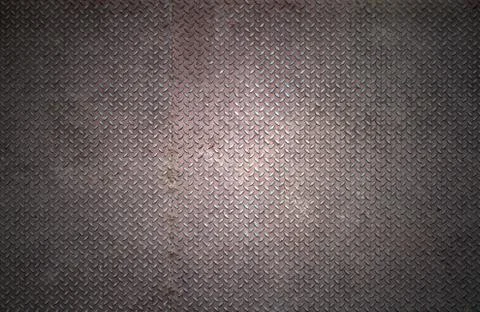 Old checker plate background with rust condition. Stock Photos