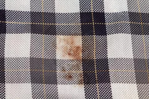 Old checkered black and white fabric with a blood stain Foto stock