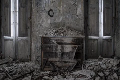 Old chest of drawers with collapsed ceiling in large abandoned house Stock Photos