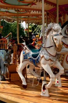 Old children's carousel with different animals and a horse close-up Stock Photos