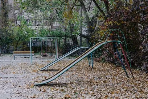 An old children's playground with metal elements in the Soviet Courtyard Stock Photos