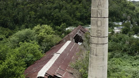 The old chimney stack and collapsing rooftops of a long-abandoned Video stock 159203910