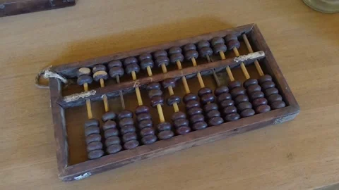 Old Chinese old-fashioned abacus beads on indoor desktop Stock Footage 159842105