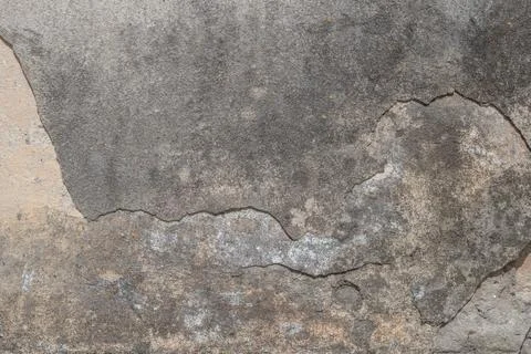Old chipped plaster on the concrete wall, gray texture, background Stock Photos