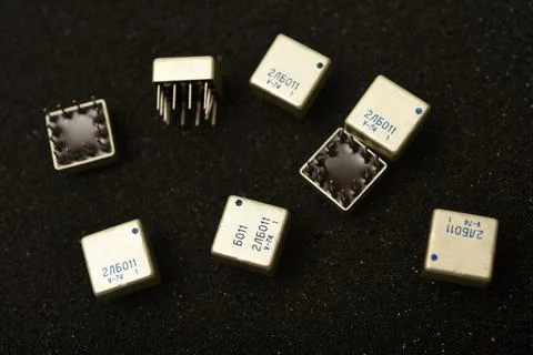 Old chips on a black background. Microchips on foam rubber. Microcircuits. Stock Photos