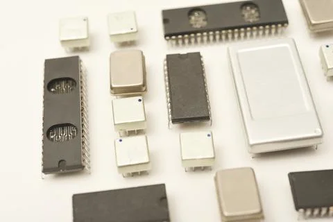 Old chips on a white background. Electronic components. Processors in metal.. Stock Photos
