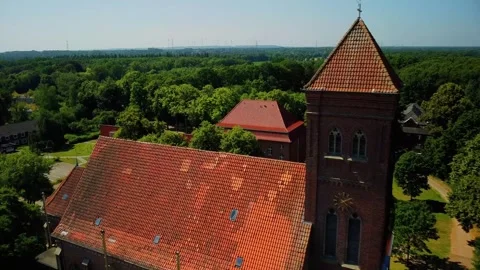 Old church located in a forest area with tall trees and clear sky on a sunn.. Stock Footage 339782659