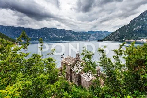 The old church overlooking the sea in bad weather Stock Photos