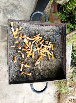 Old cigarettes filter in ashtray Stock Photos