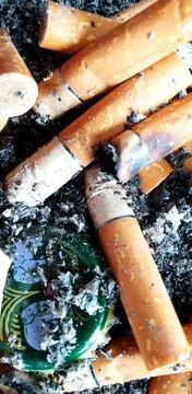 Old cigarettes filter in ashtray Stock Photos
