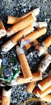 Old cigarettes filter in ashtray Stock Photos