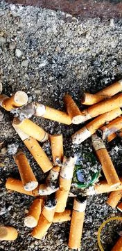 Old cigarettes filter in ashtray Stock Photos