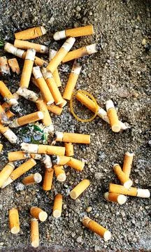 Old cigarettes filter in ashtray Stock Photos