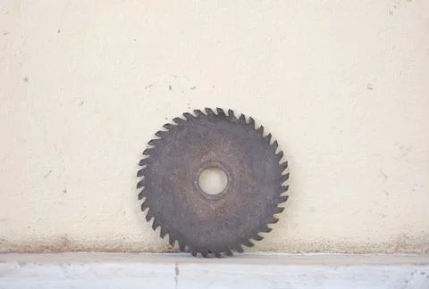 Old circle sharp diamond blade leaning on the wall Fotos Stock