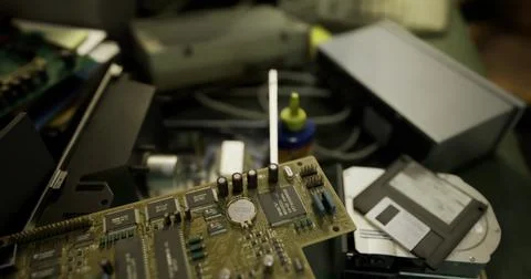 Old circuit board and various electronic components scattered on a worktable Stock Illustration