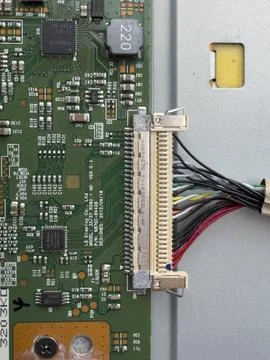 Old circuit board with small and large parts and connectors. Stock Photos