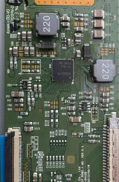 Old circuit board with small and large parts and connectors. Stock Photos