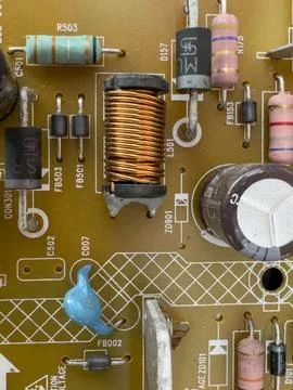 Old circuit board with small and large parts and connectors. Stock Photos