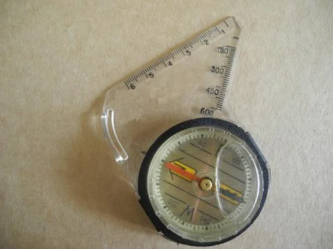 Old classic navigation compass on beige background as symbol of tourism, tr.. Stock Photos