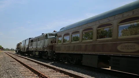 Old classic passenger train car slowly moving on railroad tracks. Leaving sto Stock Footage 112810289