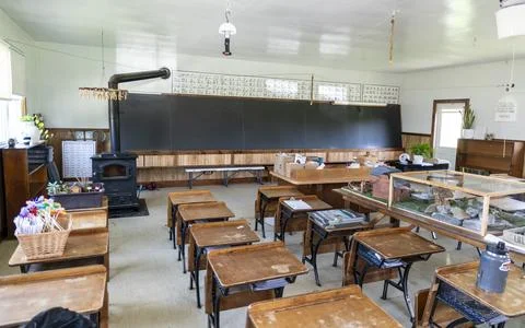 Old Classroom With Empty Desks and Blackboard in a Rural School Setting Stock Photos