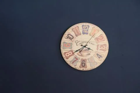 Old clock on the navy blue wall Stock Photos