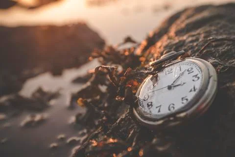 Old clock on a rock by the ocean Stock Photos