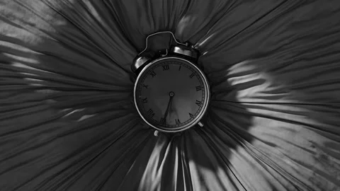 An old clock sinks into fabric in black and white Stock Footage 253562922