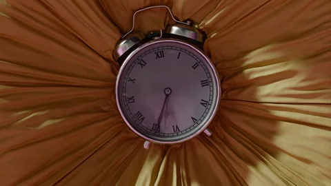 An old clock sinks into yellow fabric Stock Footage 253563743