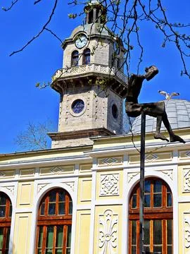 The old Clock Tower and a creative bronze monument with a seagull. Stock Photos