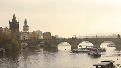An old clock tower near the bridge in Prague, a bridge across the river in the o Видео 83416312