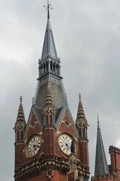 An old clock tower rises against a stormy sky. Stock Photos