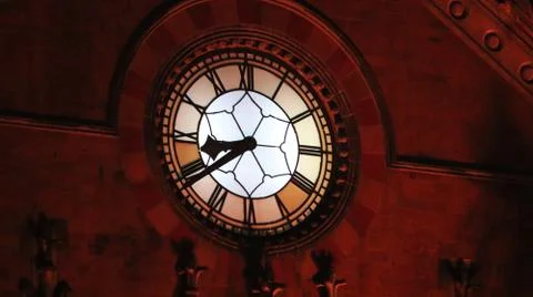 An old clock tower shining in the night light. Stock Photos