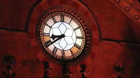 An old clock tower shining in the night light. Stock Photos